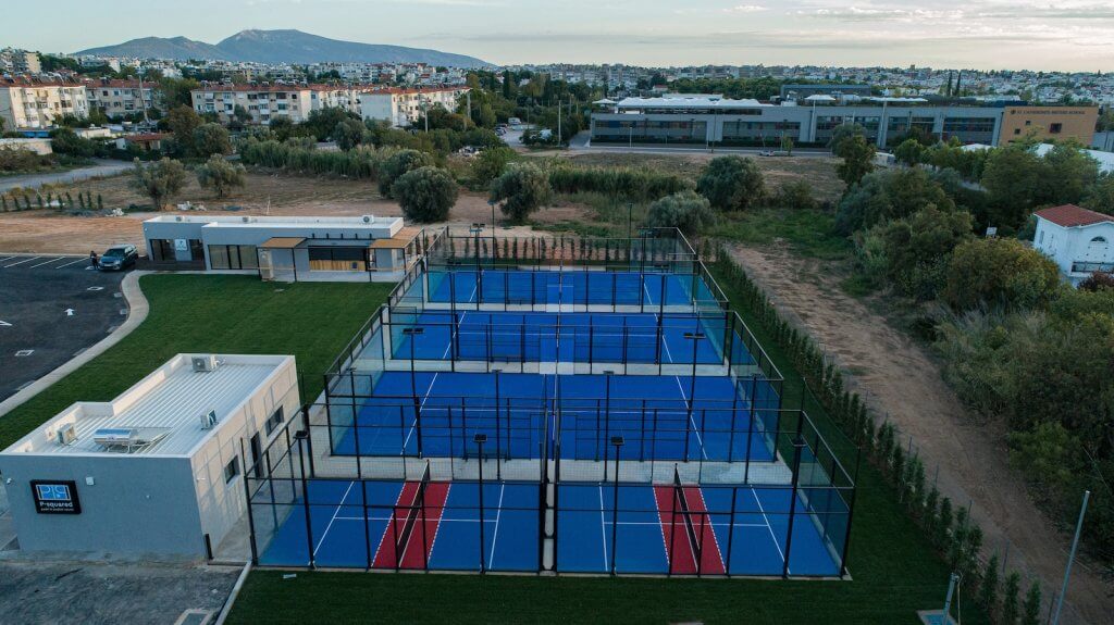 an aerial view of a padel court in a residential area, sports ground construction